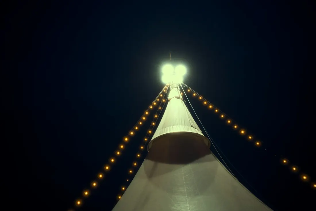 Sample photo: tent peak at night lit by strands of bistro lights