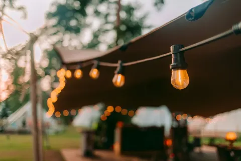 Sample photo: close-up of bistro bulbs under a tent edge